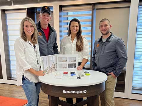 Company staff posing for a photo in the showroom