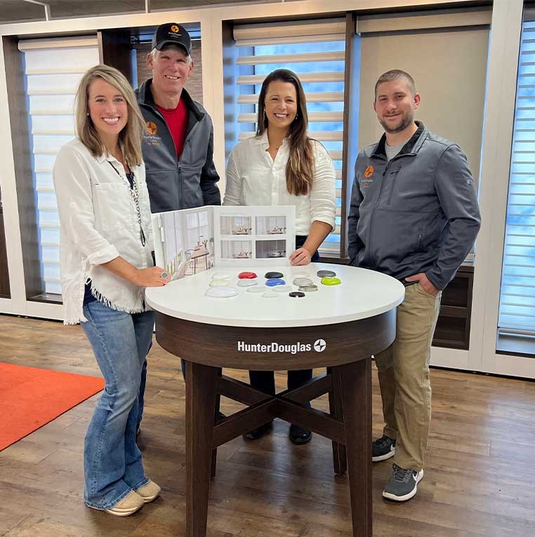 Company staff posing for a photo in the showroom